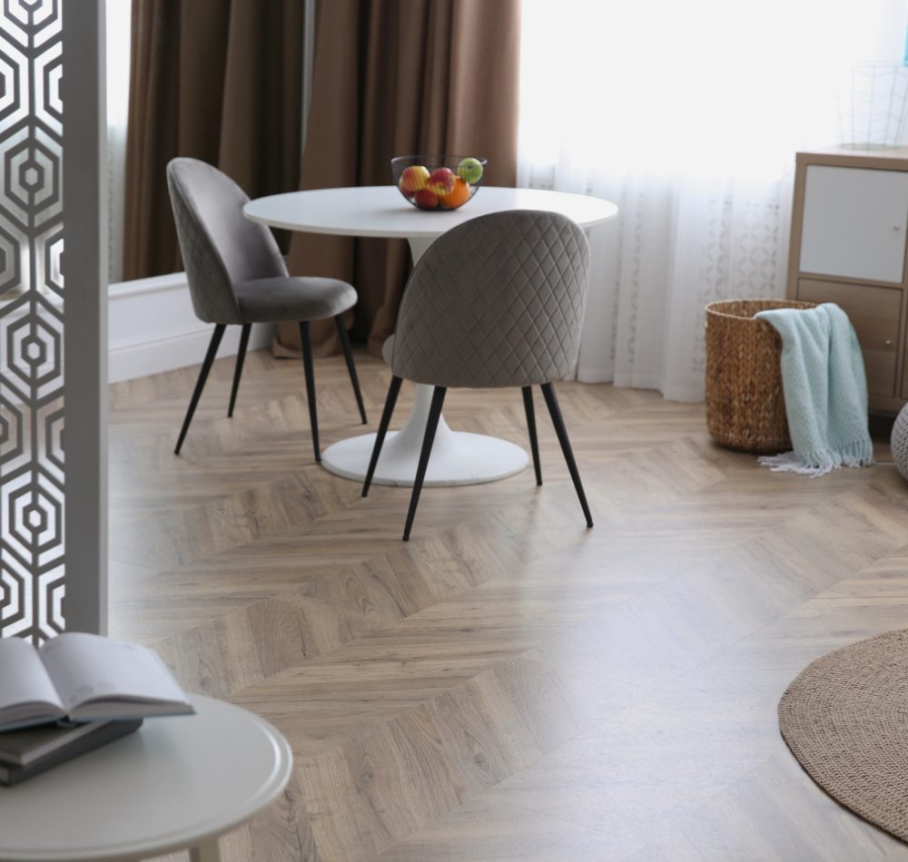 Modern living room with parquet floor and stylish furniture